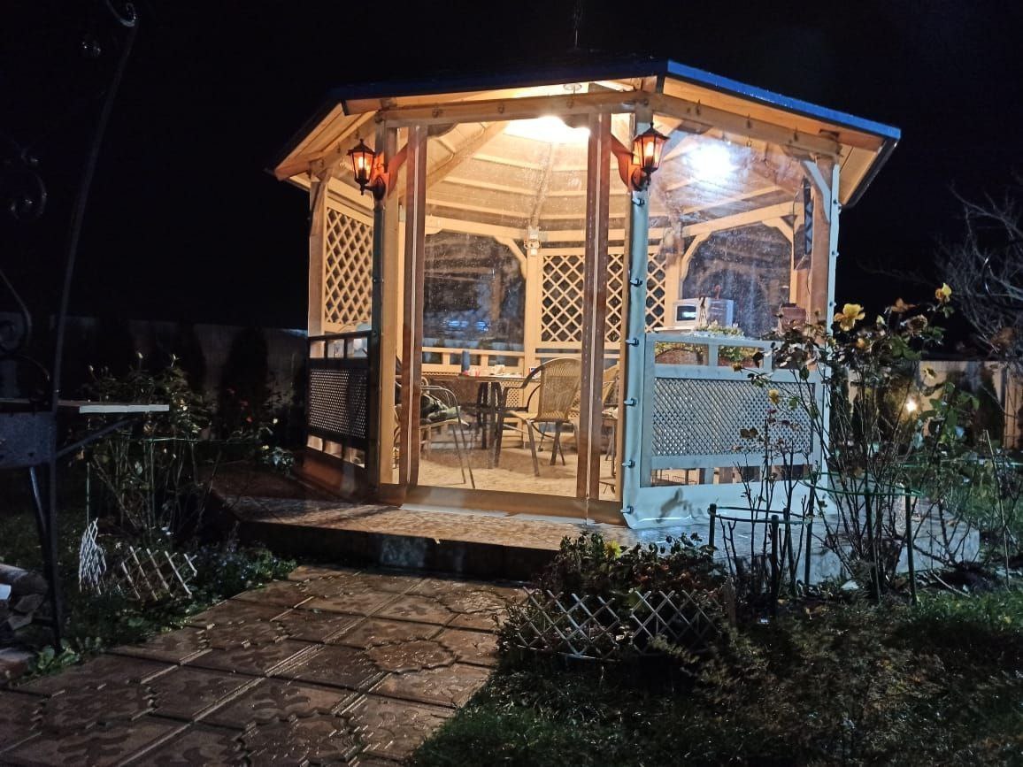 Мягкие окна ПВХ на освещенной садовой беседке в Советске